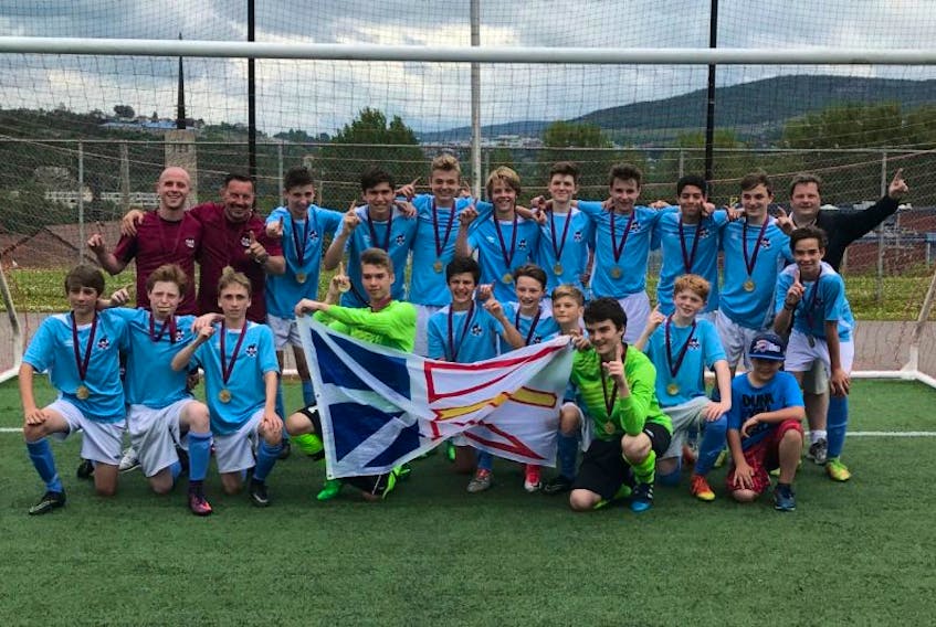 Members of Newfoundland and Labrador’s under-14 boys soccer team celebrate after defeating New Brunswick 2-1 Sunday in the gold-medal game of the Atlantic championship in Corner Brook.