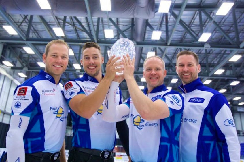 Brad Gushue (right) and teammates (from left) Geoff Walker, Brett Gallant and Mark Nichols hoist the championship trophy after winning the Tour Challenge in Regina on Sunday.