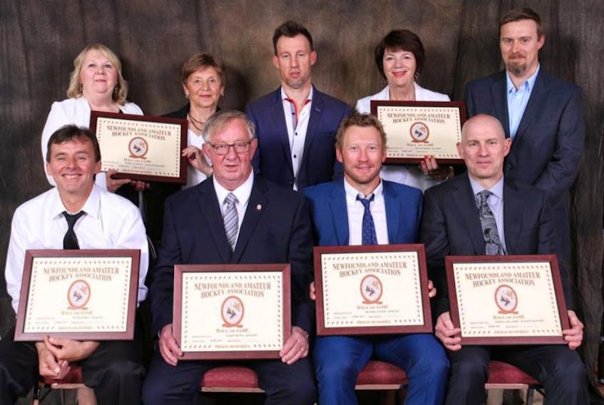 Six new members were inducted into the Newfoundland and Labrador Hockey Hall of Fame during Hockey Newfoundland and Labrador’s annual general meeting in Gander over the weekend. Inducted, and among those representing inductees, were (from left) first row: Ed Kearsey, Glenn Critch, Michael Ryder, Darryl Williams; back row: representing Derek Clancey were his sister, Beverly Pope, and mother Geraldine Clancey, and representing Kevin “Fox” Fagan were his son, Shaun Fagan, wife Debbie and his son, Corey Fagan.
