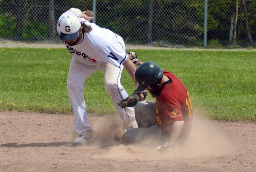 Holy Cross baserunner Dean Hammond slides safely into second base ahead of a tag by Gonzaga Vikings shortstop Gerald Butt during St. John’s senior baseball action at St. Pat’s Ball Park on Sunday afternoon. The Crusaders spent a lot of time on the basepaths Sunday as they rolled to a 15-4 win. 
