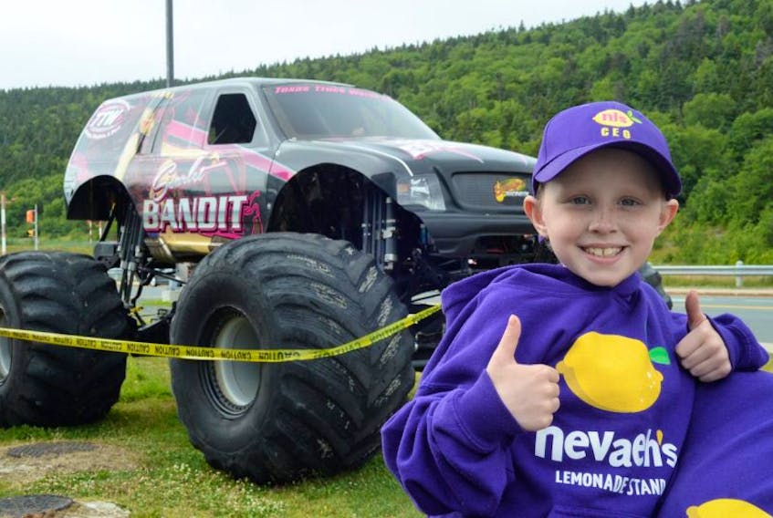 Seven-year-old Nevaeh Denine of Goulds shows her opinion of the monster truck Scarlet Bandit outside the Janeway in St. John’s Friday. Nevaeh will be the honourary race starter Saturday Eastbound Park in Avondale Saturday as the Scarlet Bandit, Bounty Hunter and other monster trucks take part in the NAPA Auto Parts World Series of Monster Trucks.