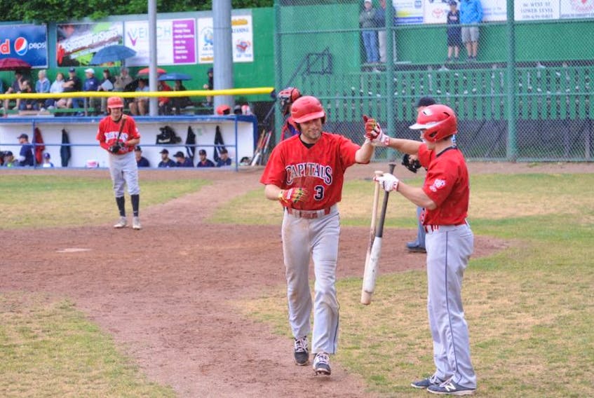 Trevor Clarke (3) is congratulated by St. John’s Capitals teammate Andrew Paul after smacking a solo home run against the Corner Brook Barons in Game 1 of the provincial senior A baseball final at Jubilee Field in Corner Brook on Saturday. The Barons won the first game of the best-of-seven series, but the Capitals prevailed in the next two contests to take the lead in a best-of-seven series that switches to St. Pat’s Ball Park in St. John’s next weekend.