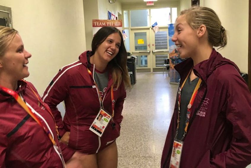 Newfoundland and Labrador swimmer Kate Sullivan (right) shares a laugh with coaches Duffy Earle (left) and Erika Butler during a visit to Canada Summer Games mission staff headquarters at the University of Manitoba.