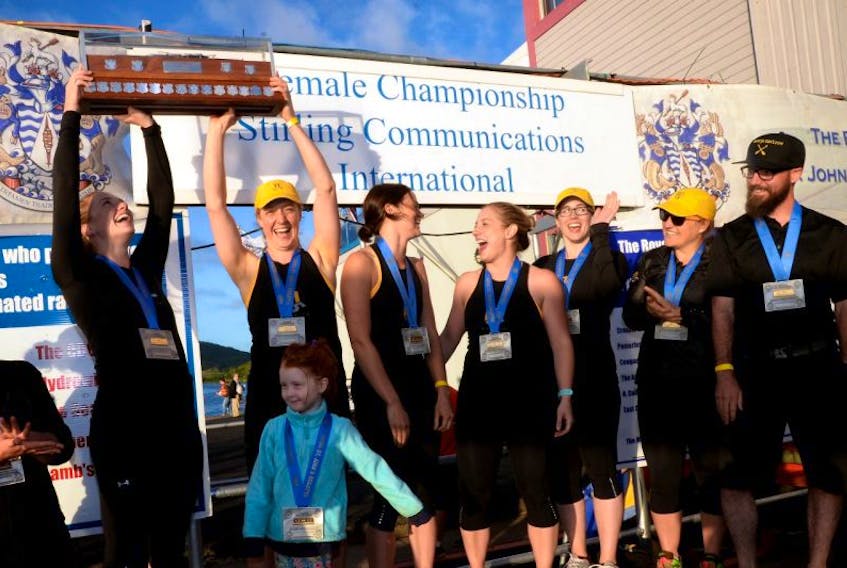 Members of the M5 crew hoist their trophy after winning the women’s championship race for the second straight year at the Royal St. John’s Regatta Wednesday. The crew are (from left) Alyssa Devereaux, Nancy Beaton, Kate Wadden, Amanda Ryan, Jane Brodie, Amanda Hancock and coxswain Dean Hammond.
