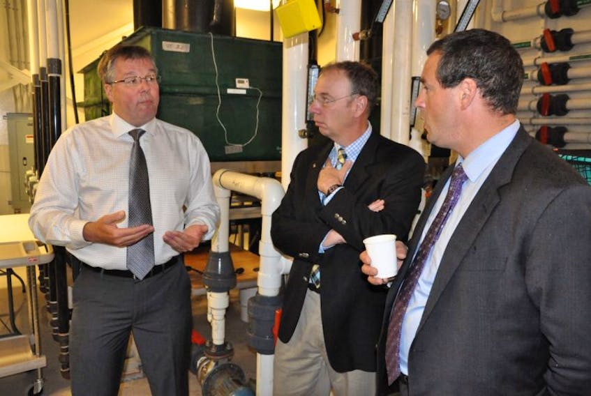Memorial University faculty of science professor Kurt Gamperl (left) speaks with MUN vice-president of research Ray Gosine (centre) and St. John’s East MP Nick Whelan during a tour of some sections of the Ocean Sciences Centre, where a pan-Atlantic research initiative into the health and welfare of farmed salmon will take place. 
