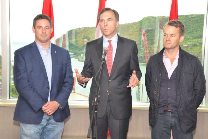 Federal finance minister Bill Morneau (centre), flanked by Newfoundland and Labrador MPs Nick Whalen (left) and Seamus O’Regan, speaks to the media following a roundtable discussion about the proposed federal tax changes. Morneau says the changes are not targeting small business owners, but wealthy Canadians who are exploiting loopholes in the tax system that allow them greater advantages than regular Canadians.