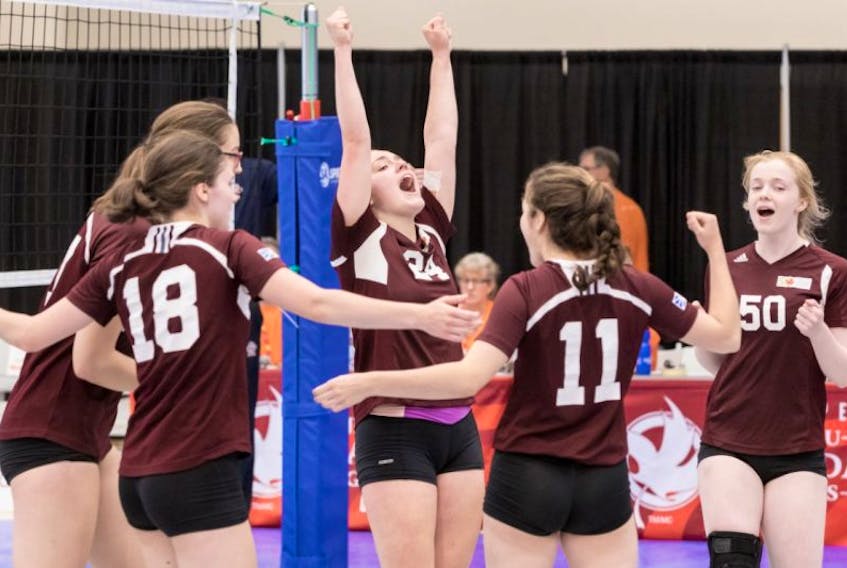 Newfoundland and Labrador teammates Erin Grabka (18), Hailey Oke (behind Grabka), Margaret Henley (24), Hannah Grabka (11) and Caroline Walsh (50) celebrate a point in their game against Alberta Monday. It was Newfoundland’s first game, and the team lost 3-0 (25-13, 25-19, 25-9).