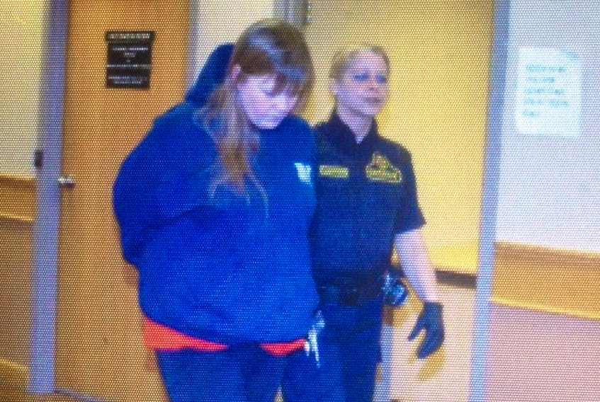 Cathy Snow is escorted out of Courtroom No. 7 in provincial court in St. John’s Friday afternoon.