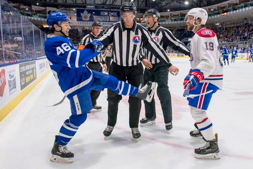 Bobby Farnham (right) and the IceCaps face off against Trevor Moore (left) and the Marlies today in Toronto in a game with an 11 a.m. Eastern time start.