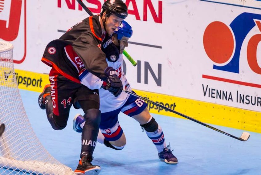 Patrick O’Keefe (11) of Mount Pearl a defenceman with Team Canada, fights off a Slovak forward behind the Canadian net during their game Tuesday at the International Street and Ball Hockey Federation’s world championship in Pardubice, Czech Republic.