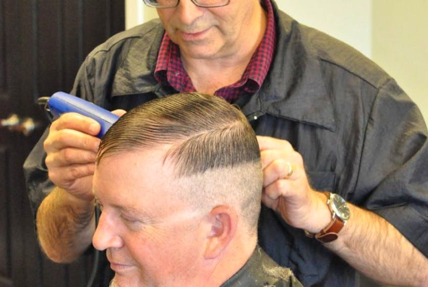 Barry Cutler works on customer Chris Meadus Friday morning at Straight Edge Barbers at Ropewalk Plaza in St. John’s. Cutler and his business partner, Linda Scanlon, left Central Barber Shop in the Avalon Mall, where they worked for a combined 66 years, to start the new shop.