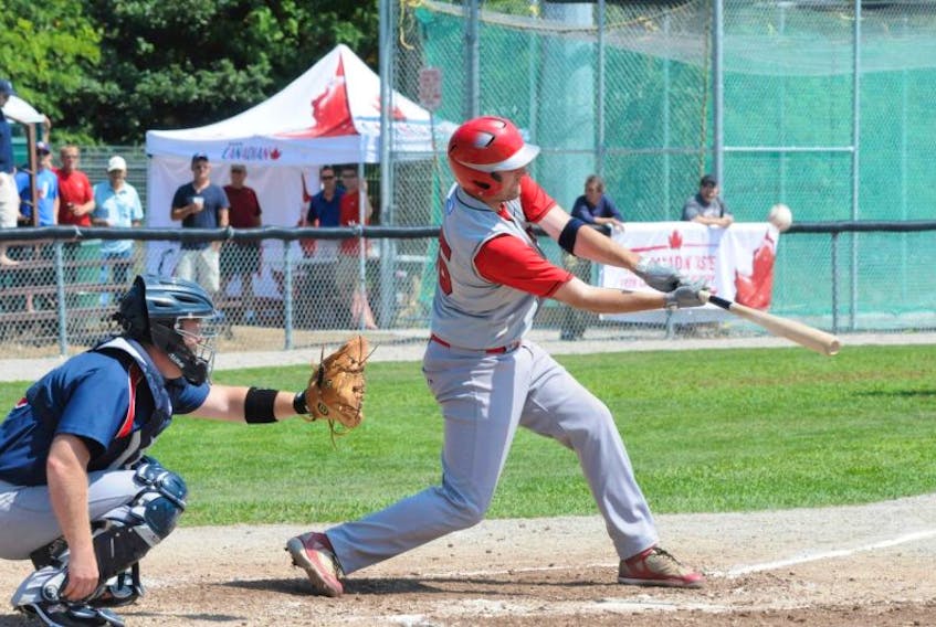 In this Aug. 5, 2012 file photo, Corner Brook Barons catcher Darren Colbourne looks on as Cory Ewart collects a hit during the opening game of the provincial senior baseball final at St. Pat's Ball Park in St. John’s. The longtime competition between the senior Barons and Capitals is the subject of a new book by former St. John’s pitcher Dan Reardon.
