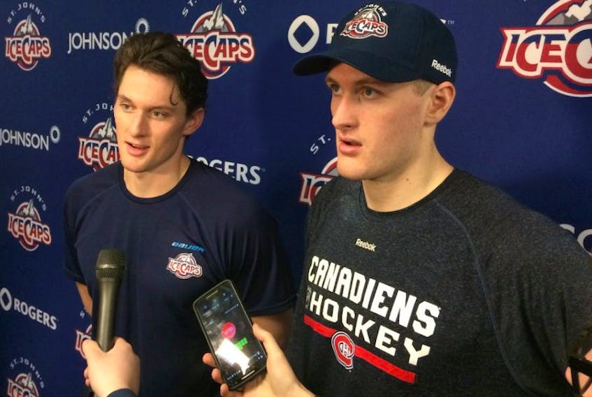 The McCarron brothers, John (left) and Michael, speak to the media after suiting up for the St. John’s IceCaps in an American Hockey League game against the Utica Comets Wednesday night at Mile One.