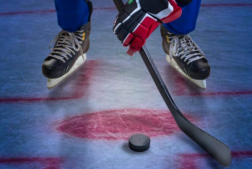 Hockey player stand on face-off spot. Legs only view