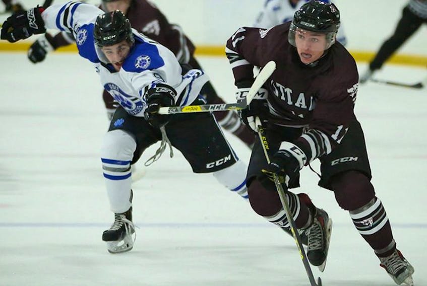 In this Oct. 7, 2016 file photo, University of Ottawa GeeGees forward Cody Drover (11) skates away from the check of Ottawa Institute of Technology Ridgebacks winger Anthony Latina (9) during collegiate hockey action in Ottawa. Drover had a slow start to his first university season, but the Grand Falls-Windsor native has been on a roll recently … and so have the GeeGees.