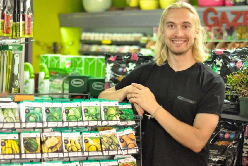 Jackson McLean, assistant manager at The Seed Company by E.W. Gaze, stands next to a rack of seeds offered by the downtown St. John’s shop. Starting next spring, the company’s contract with Sobeys to have seed racks in all its Newfoundland and Labrador locations — including Foodland and Co-op franchises — will be expanded to include the rest of Atlantic Canada.