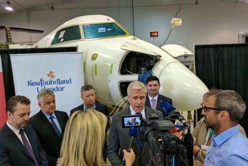 Premier Dwight Ball answers questions from the media following an announcement of $3 million in provincial funding toward PAL Aerospace’s Force Multipler project. At the premier’s left are PAL Group CEO Brian Chafe, Atlantic Canada Aerospace and Defence Association provincial director Jim House, Newfoundland and Labrador Association of Technology Industries CEO Ron Taylor and Minister of Tourism, Culture, Industry and Innovation Christopher Mitchelmore.