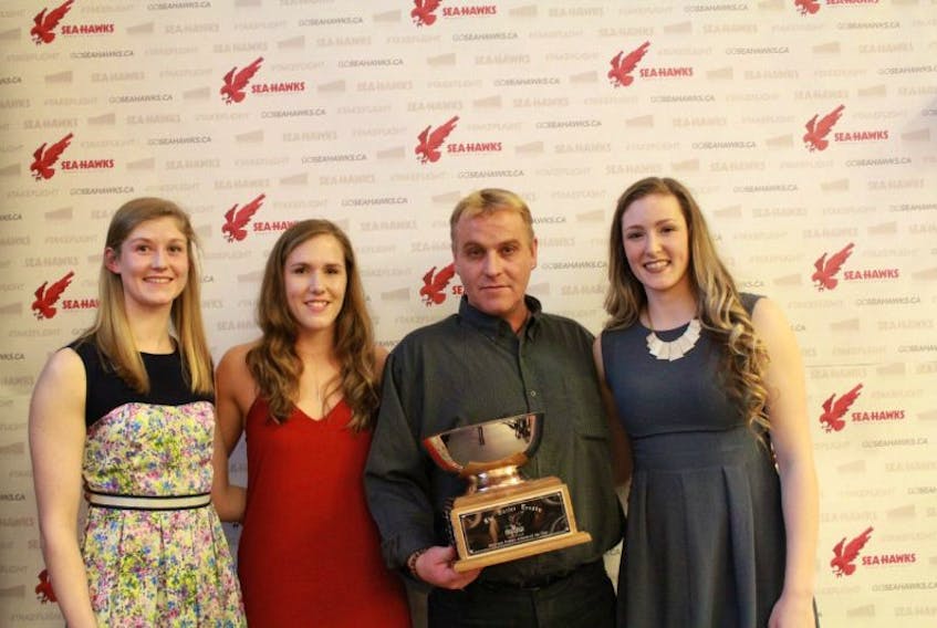 Swimmer Veronica Reid, soccer player Jessie Noseworthy and volleyballer Jill Snow are the 2016-17 co-winners of the Butler Trophy as the MVP among Memorial Sea-Hawks female varsity athletes. Posing with Reid (left), Noseworthy (second from left) and Snow (right) is Keith Butler.