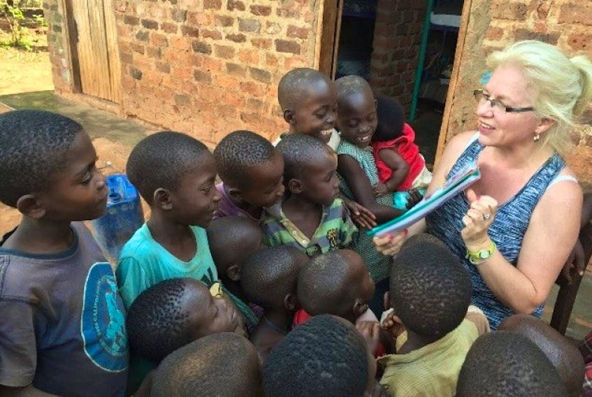 Marjorie Williams reading to orphan children in Uganda.