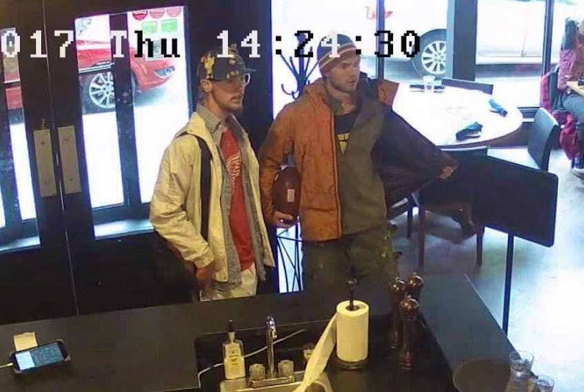 Security footage from The Fifth Ticket in downtown St. Johns shows Benjamin Boucher (left) and François Boucher.