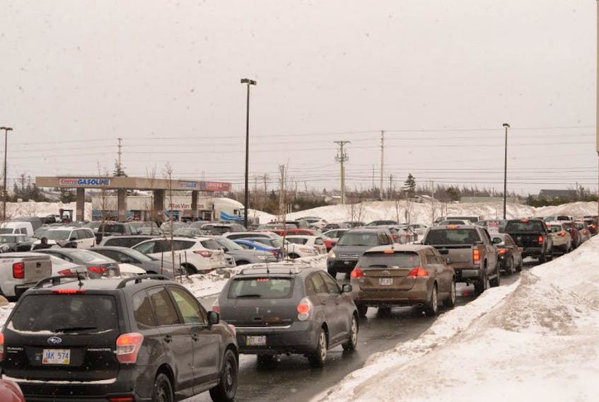 Vehicles line up at the Costco gas bar on Stavanger Drive on Monday.