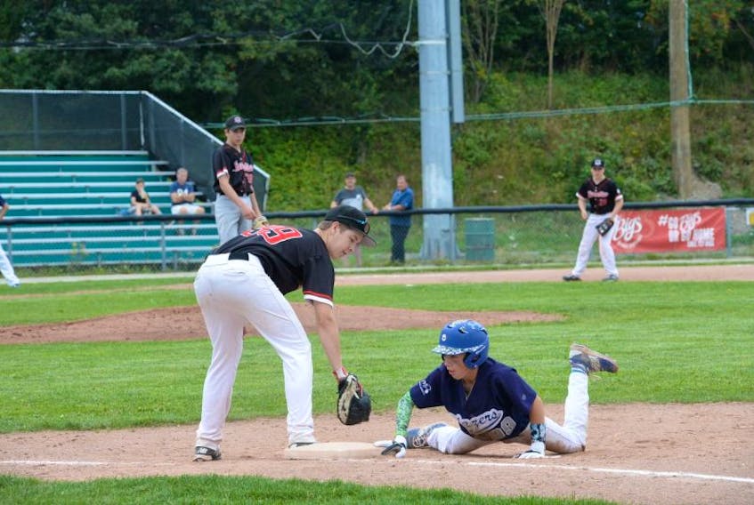 Ryan Hounsell of the Mount Pearl Blazers scurries back to first base safely after a pick-off attempt from Paradise Phantoms pitcher Nick Williams to first baseman Devon House during their game Friday in Sportscraft midget AA provincial baseball tournament at St. Pat’s Ball Park. Looking on is Phantoms third-baseman Keegan Hynes. The Blazers, who had lost 5-0 to the host St. John’s Capitals in the tournament’s opening game, rebounded for a 16-0 victory over Paradise. Round-robin play in the six-team tourney — Conception Bay South, Grand Falls-Windsor and Corner Brook are also entered — continues today and Sunday, with the final set for 4 p.m. Sunday. Meanwhile, the provincial bantam A tournament is being held in Mount Pearl, where three teams — St. John’s, Paradise and host Blazers — are competing en route to another Sunday final.
