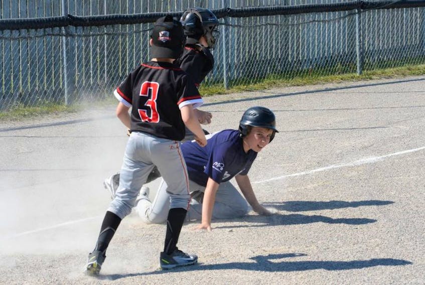 James Eales of the Mount Pearl Blazers is tagged out by Paradise Phantoms catcher Stephen Vatcher after trying to steal home on a passed ball during their mosquito B game in the 2017 Festival of Baseball tournament at the Chapman Crescent Playground Lions Field in Kilbride on Friday afternoon. Looking on is Phantoms pitcher Ethan Collins. 