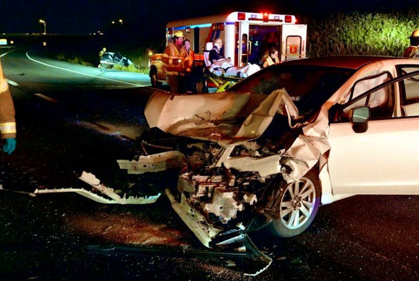 The driver of a car is placed aboard an ambulance following a moose collision on the Outer Ring road Wednesday night.