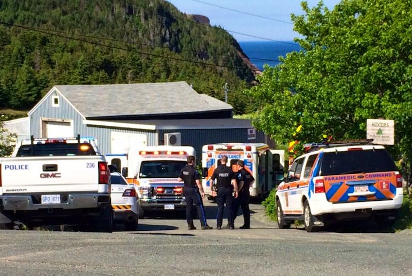 Police and emergency personnel vehicles near the swimming hole off Windgap Road in Flatrock on Tuesday.