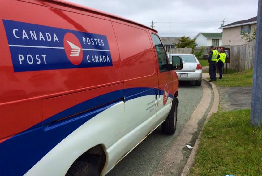 Two Canada Post employees are shown alongside a Royal Newfoundland Constabulary (RNC) street patrol unit following an incident involving the a mailbox on the corner of Frontenac Street and Hemmer Jane Drive in Mount Pearl over the noon hour Wednesday.