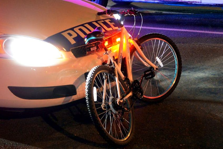 Officers with the Royal Newfoundland Constabulary investigate a bicycle-vehicle collision Thursday night.