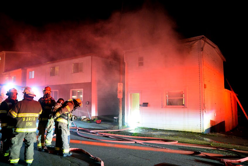 Firefighters rescued two men from the roof of buring home early Monday morning in St. John's. Keith Gosse/The Telegram