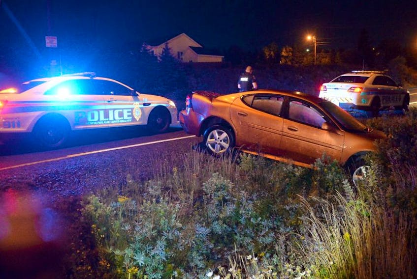 A motor-vehicle collision early Tuesday morning left this car in a ditch on Mount Scio Road. 