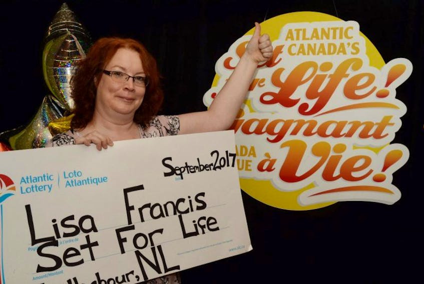 Lisa Francis with her symbolic cheque that was presented to her by Sarah Breen of Atlantic Lottery.