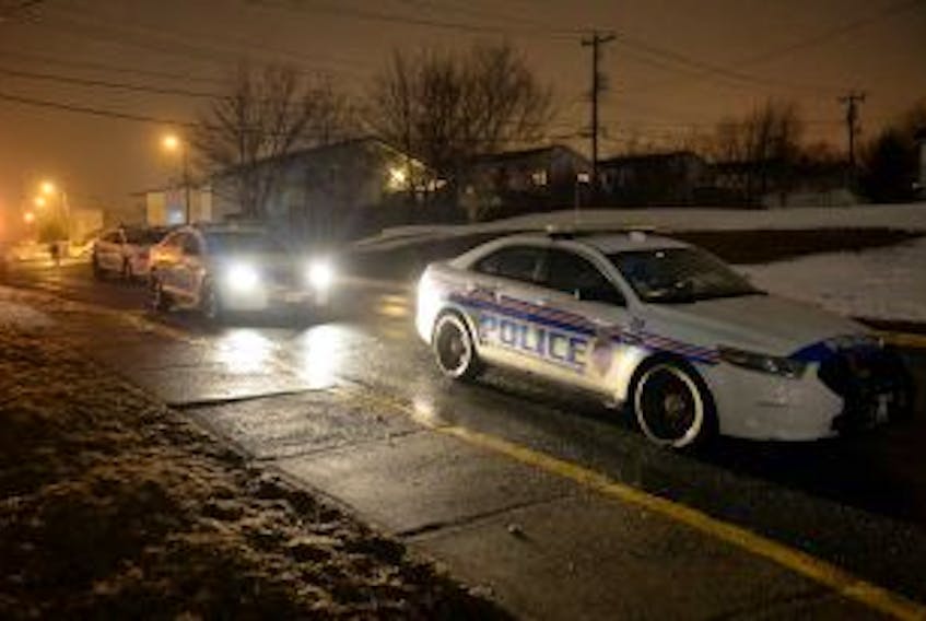 ['Several police cruisers sit parked near the scene of the collision.']