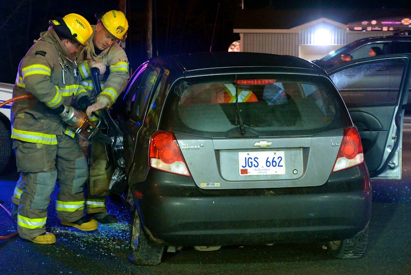 Firefighters from the St. John’s Regional fire department had to use extrication tools Monday night to remove the injured driver of a car involved in a two-vehicle collision at the intersection of Kenmount Road and Wyatt Boulevard. Keith Gosse/The Telegram