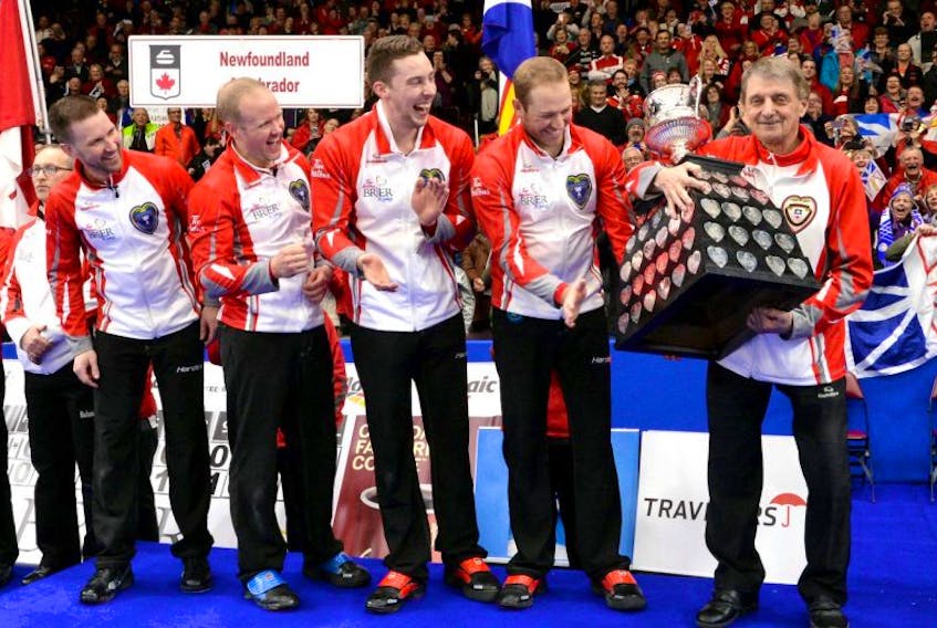 Team Newfoundland and Labrador coach Jules Owchar (right) hugs the Brier Tankard after the team won the 2017 Tim Hortons Brier at Mile One Centre Sunday night. Left to right are Brad Gushue, Mark Nichols, Brett Gallant, Geoff Walker and Owchar.Keith Gosse/The Telegram