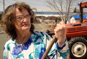 Linda Clarke takes a break from raking her front lawn, Tuesday in Chamberlains. The small submitted photo below is from a few years ago, before she started having dental problems.
