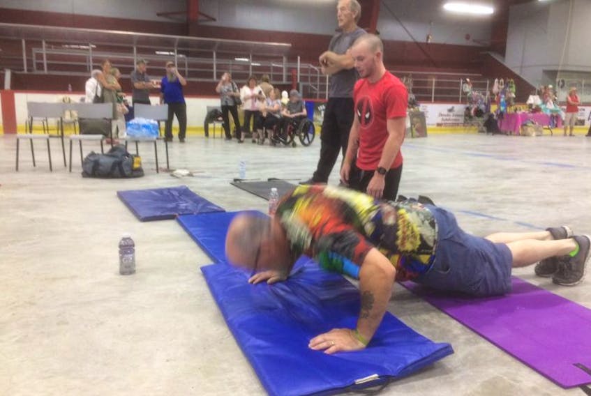 Bill Guiney was doing pushups so quickly on Saturday that he was little more than a blur as his team members waited their turn at the Southern Shore Arena.
