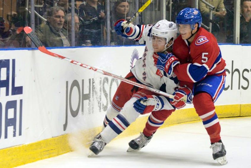 St. John's IceCaps defenceman Tom Parisi (right) and John Gilmour of the Hartford WolfPack get tangled up behind the IceCaps' net during AHL action at Mile One Centre Friday night.

