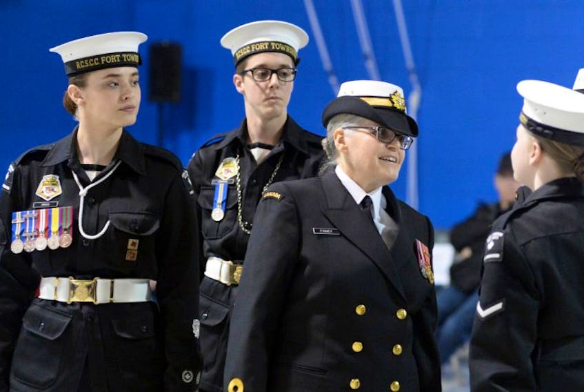 Chief Petty Officer Second Class Madelyn Drover (left) guides Lt. Cdr. Valerie Finney on an inspection of the corps' cadets during the review. At rear is Chief Petty Officer Paul Edwards.
