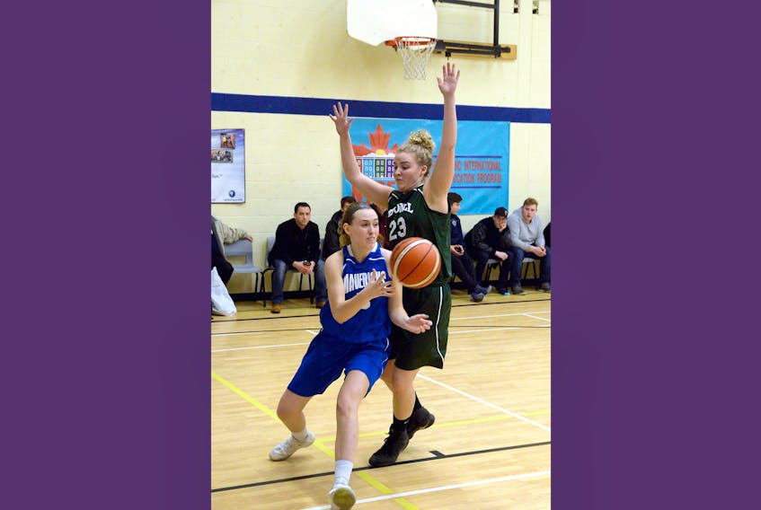 Emma Power (left) of the host St. Kevin's Mavericks makes a pass as Katie Cousens of the O'Donel Patriots guards her during provincial girls 4A high school basketball action in Goulds Thursday evening. The Mavericks won 81-53.