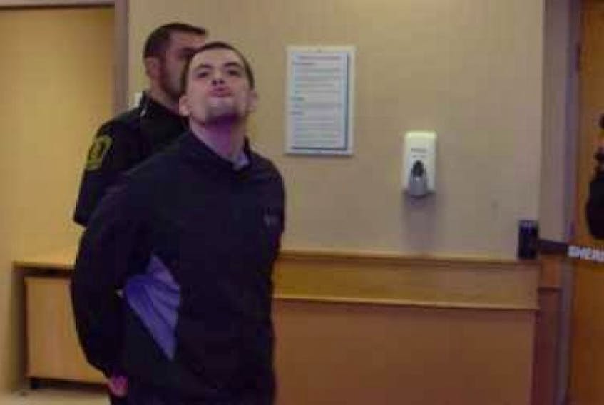 Justin Michael Jordan (aka Hussey) blows a kiss to reporters while being escorted out of the courtroom at provincial court in St. John's Thursday. Jordan is accused of trying to kill accused murderer Trent Butt while the two were at Her Majesty's Penitentiary last week.