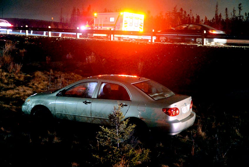 A car sits in a median after it went off the road Saturday night on the Team Gushue Highway. Keith Gosse/The Telegram