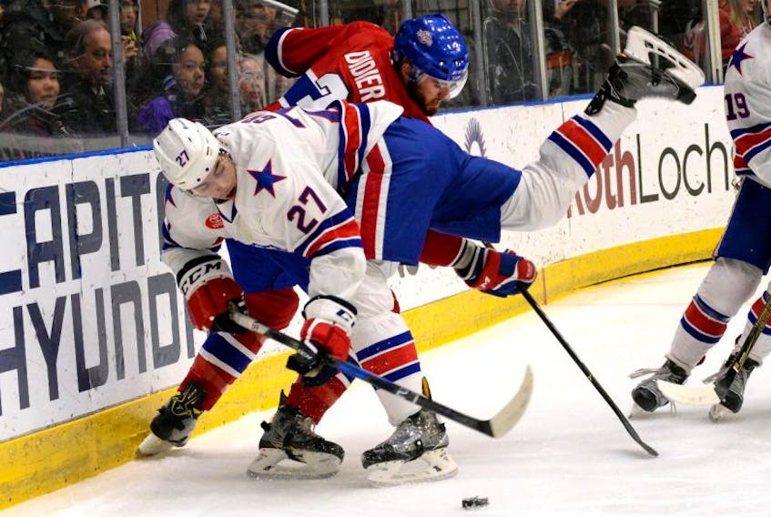 St. John's IceCaps defenceman Josiah Didier and Rochester Americans forward Derek Grant collide behind the IceCaps' net during first-period AHL hockey action at Mile One Centre Friday night.