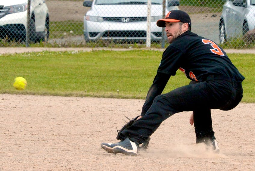 NTV Hitmen shortstop Justin Gill prepares to scoop a ball on the backhand during action in the St. John's Day senior men's softball tournamentat Lions Park Sunday afternoon.