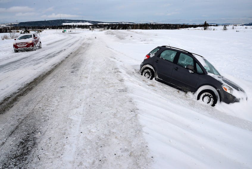 An abandoned car sits on the side of the Robert E. Howlett highway in St. John’s Sunday following Friday’s record-breaking storm. Keith Gosse/The Telegram
