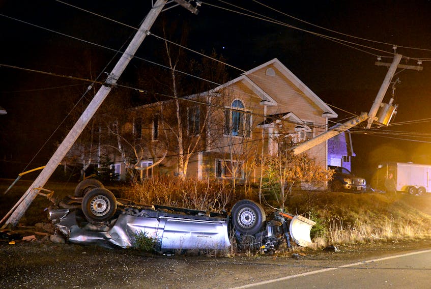 One man is in custody following a bizarre incident that ended in a crash and two electrical poles cracked off. Keith Gosse/The Telegram