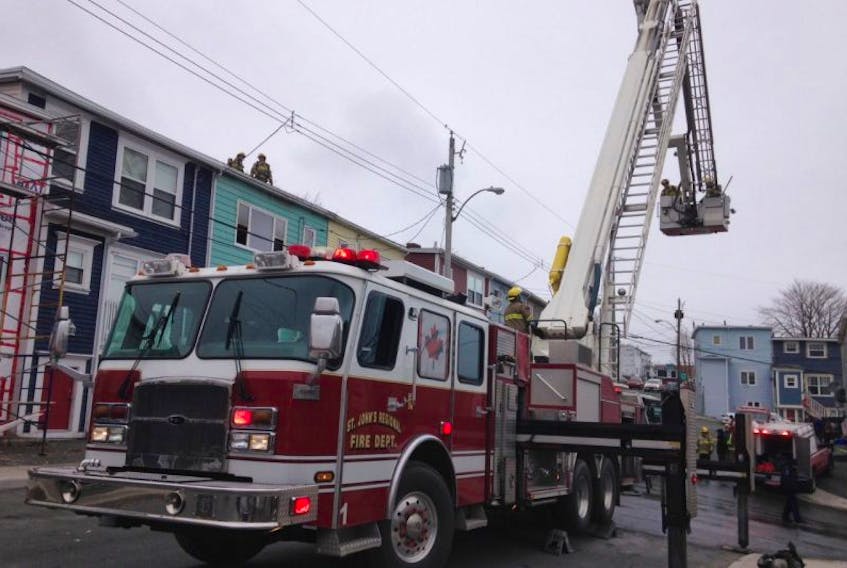Firefighters on the scene of a house fire Thursday on Monroe Street in St. John's.