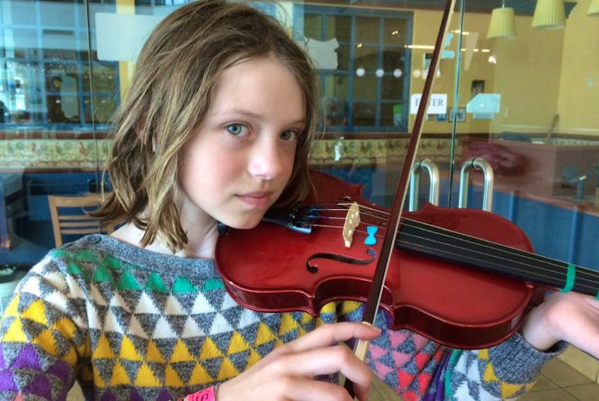 Bridget Leger, 10, prepares to play with fiddlers gathered at Atlantic Place in St. John’s Saturday just before 1 p.m. Bridgette takes part in the Strong Harbour Strings program.
